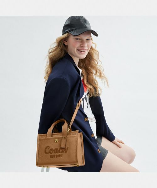 セナココCOACHブラックフード付きロングパーカー Chico（チコ）の「刺繍フードZIPパーカー（パーカー）」 - WEAR