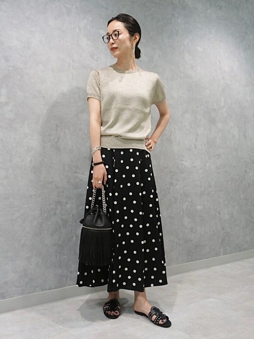 ゴールドの華やかなトップスにドットのスカートを合わせ大人カジュアルなスタイルに。トップスはキラキラと光る素材感なので、スカート・小物は全て黒で揃えてまとまり感を出しました。