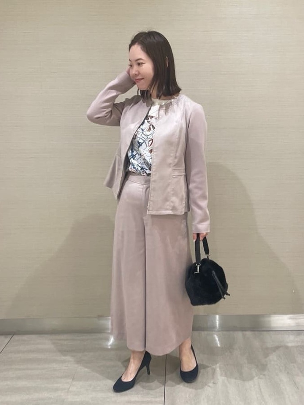 毎年人気のフェイクスェードシリーズに今年は万能カラーのピンクベージュが登場。ウエストラインが高めで脚長効果とエレガントさもあるキレイめジャケットになっています。セットで楽しめるワイドパンツもシンプルでコーディネートしやすいデザインです。【モデル身長：162cm】