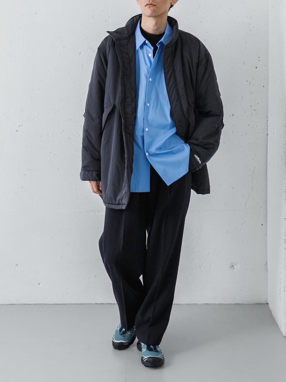 中綿ショートモッズコートとロイヤルブルーのトーマスメイソンシャツでクリーンなレイヤードスタイル。ドライウールのスラックスで上下のトーンを統一し、ゴアテックススニーカーで機能性と都会的な軽快さを加えた、洗練されたカジュアルミックスです。