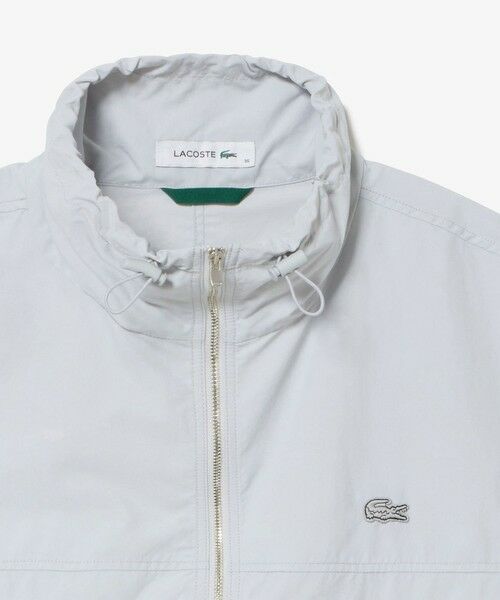 美品LACOSTE アイボリー ナイロンセットアップ セール】 撥水 ショート&ワイドシルエット スタンドカラー