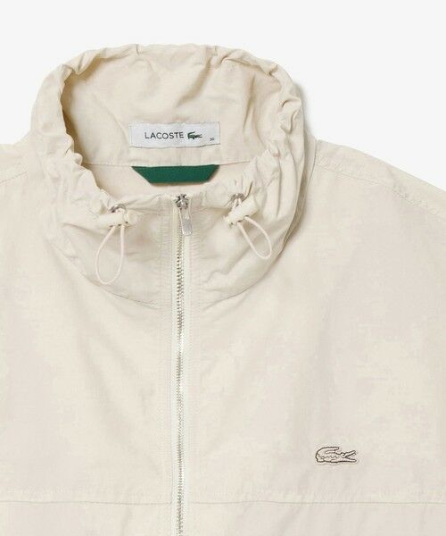 美品LACOSTE アイボリー ナイロンセットアップ セール】 撥水 ショート&ワイドシルエット スタンドカラー