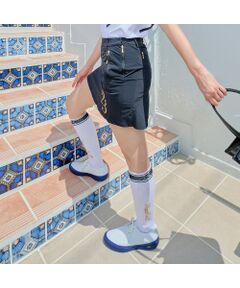 軽やかでありながら、強度のある上質素材を使用した、Nissa Golfのペプラムスカートは、上品なシルエットと機能性を兼ね備えた洗練された一着です。<br><br>最大のポイントは、Nissa Golfらしいアールの切り替えデザイン。腰回りをすっきりと見せながら、ペプラムの優雅なフレアが動くたびにふんわりと揺れ、女性らしさを際立たせます。シンプルでありながら、計算された立体感がスタイルアップを叶えるデザインです。<br><br>素材には、世界のハイブランドも採用する「LIMONTA-EAST-&reg;」の定番素材KEMIRAを使用。強度がありながらも軽く、ほどよいハリ感が美しいシルエットをキープし、光沢を抑えた上品な表面感がモードな印象を演出します。<br><br>ウエストの内側にはシリコンテープを施し、トップスをインしてもズレにくく、プレー中もシルエットをしっかりキープ。どんな動きにも美しくフィットし、ゴルフシーンでも品格を保ちます。<br><br>カラーは、視線を集める大胆なカラー配色タイプと、ゴールドプリントがアクセントのシンプルなブラックの2色展開。<br><br>さらに、同素材のウインドブレーカーとセットアップコーディネートも可能。トップスと合わせることで、より洗練された統一感のある着こなしが完成します。<br><br>■コンセプト■<br>南フランスのリゾート地ニース（プロバンス語で「Nissa」）をイメージしたゴルフブランド。美しいコートダジュールを背景にヨーロッパのエスプリを感じさせる洗練されたウェア＆グッズを展開します。<BR>